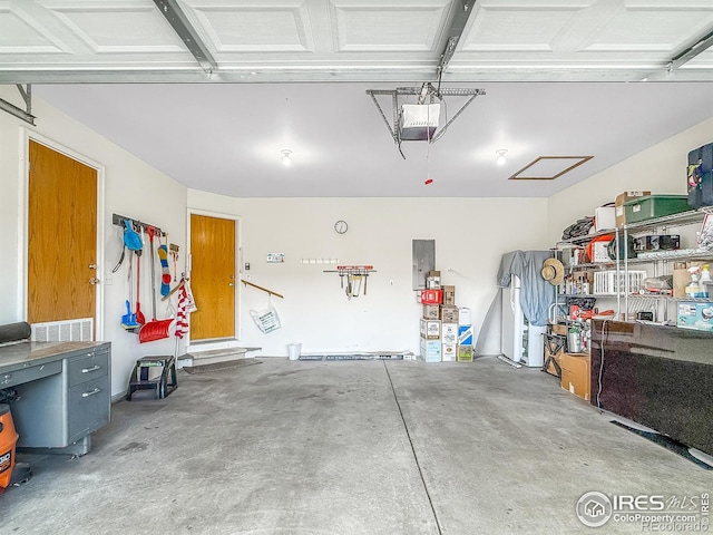 garage featuring electric panel and a garage door opener