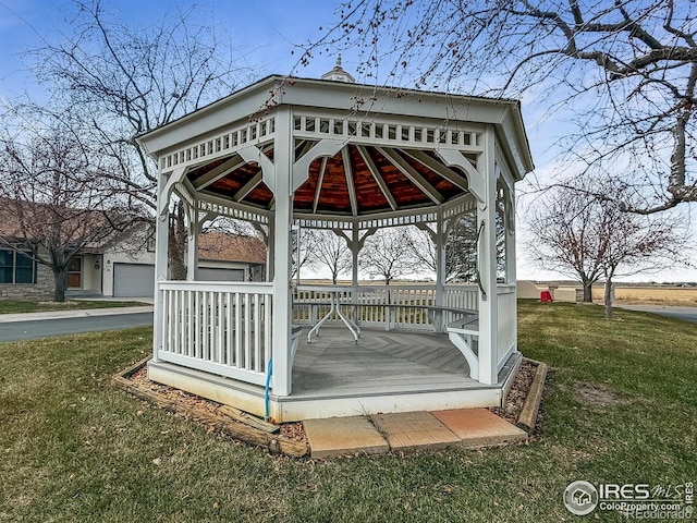 wooden terrace with a gazebo and a yard