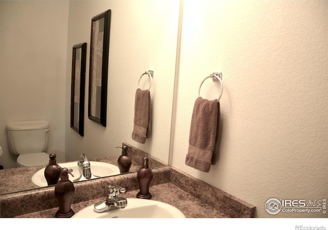 bathroom featuring sink and toilet