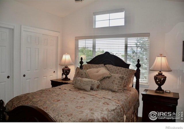 bedroom featuring lofted ceiling and a closet