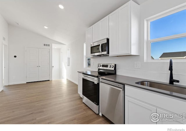 kitchen with plenty of natural light, sink, white cabinetry, and stainless steel appliances