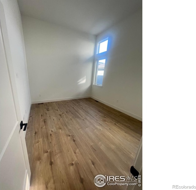 spare room featuring light wood-type flooring