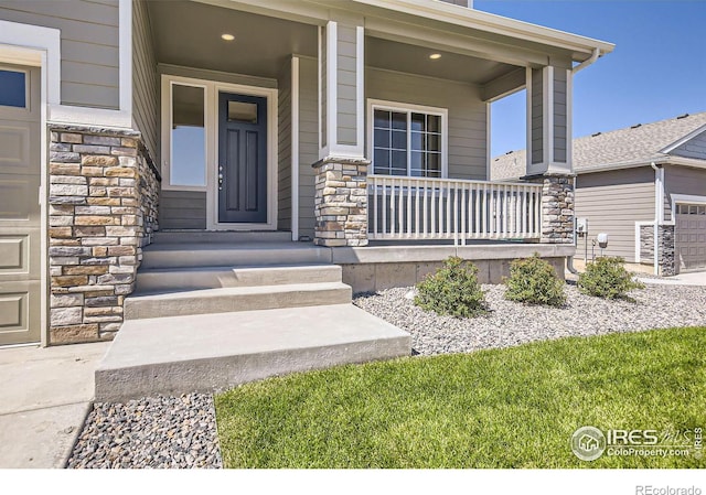 view of exterior entry with covered porch