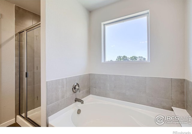 bathroom with separate shower and tub