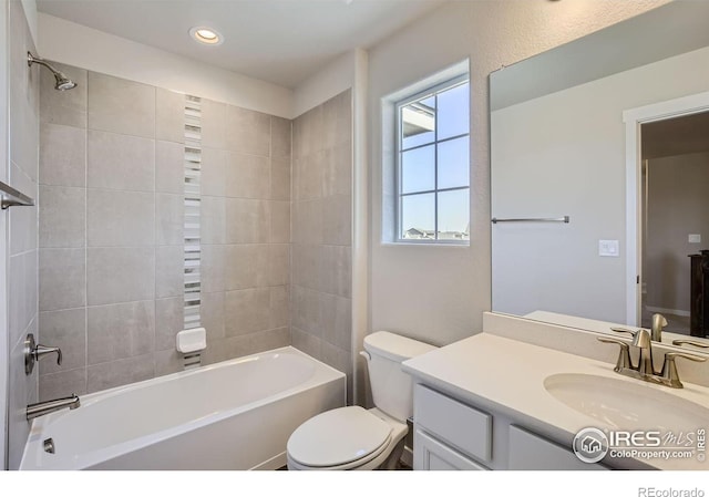 full bathroom with toilet, vanity, and tiled shower / bath