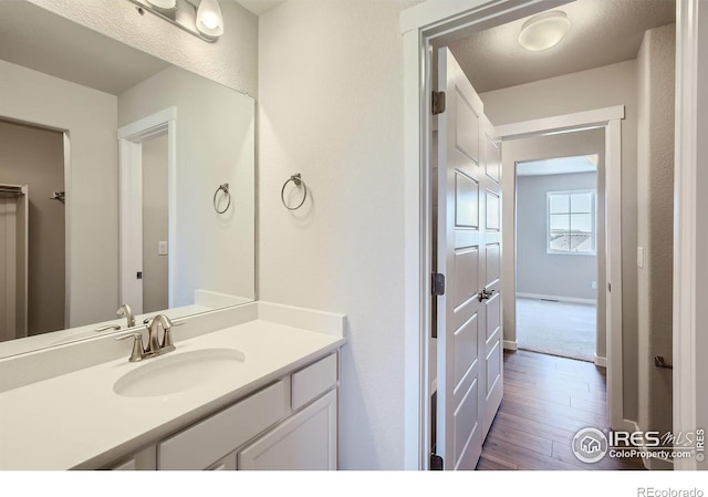 bathroom with vanity and wood-type flooring