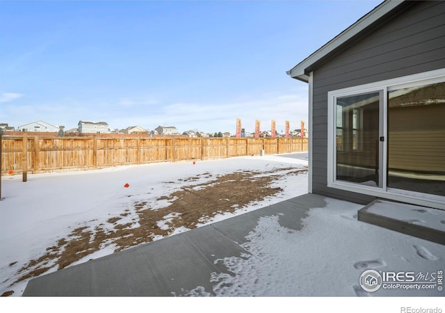 view of yard layered in snow