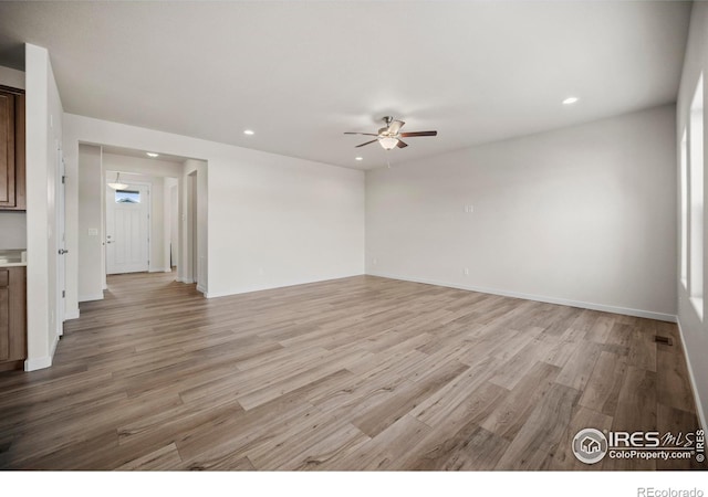 unfurnished room featuring light hardwood / wood-style floors and ceiling fan