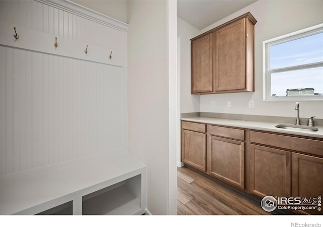 mudroom with sink and light hardwood / wood-style floors