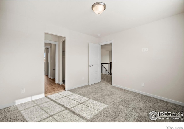 unfurnished bedroom with light colored carpet