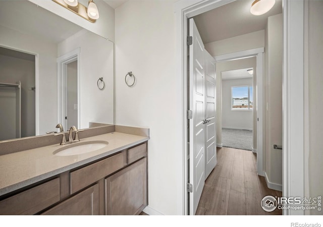 bathroom featuring wood-type flooring and vanity