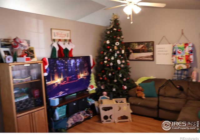 living room featuring hardwood / wood-style flooring and ceiling fan