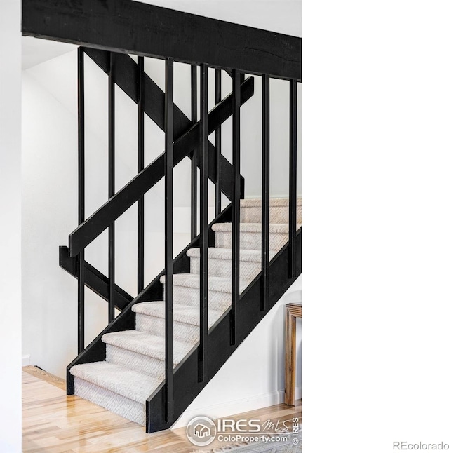 stairway with hardwood / wood-style floors