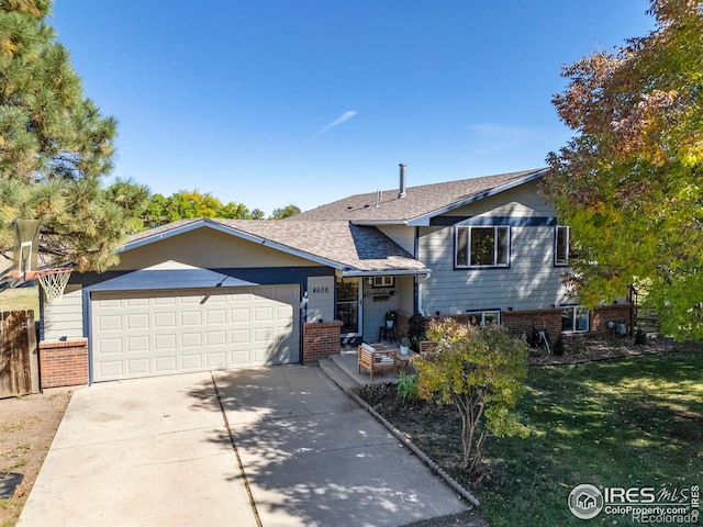 view of front of home with a garage and a front lawn