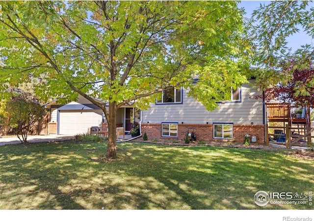 split level home featuring a front lawn and a garage