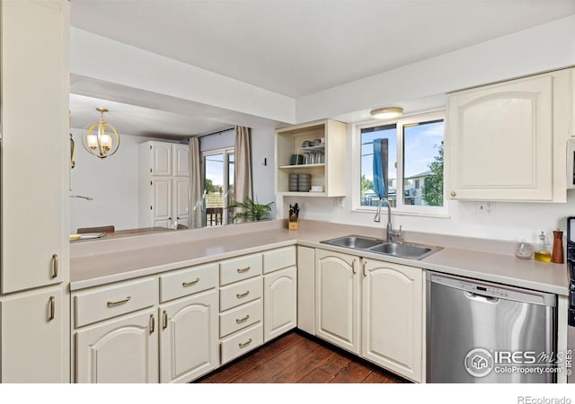 kitchen with an inviting chandelier, sink, hanging light fixtures, stainless steel dishwasher, and kitchen peninsula