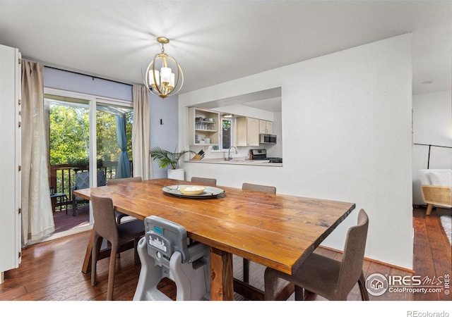 dining space with a chandelier, dark hardwood / wood-style flooring, and sink