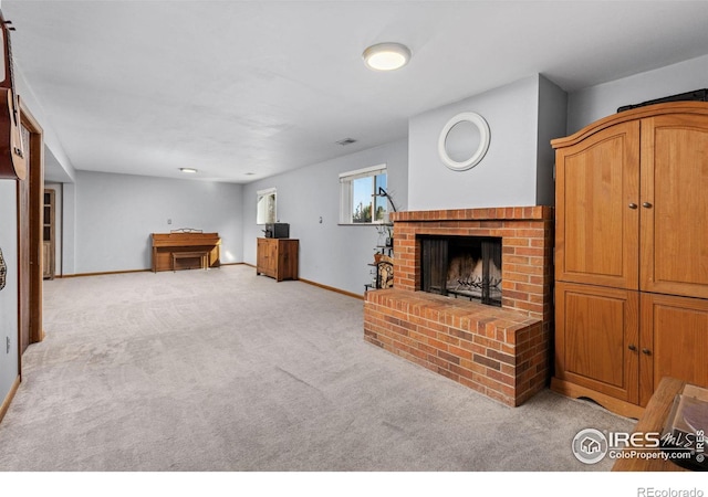 living room featuring light colored carpet and a fireplace