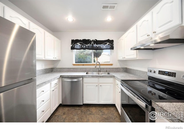 kitchen featuring appliances with stainless steel finishes, white cabinetry, and sink