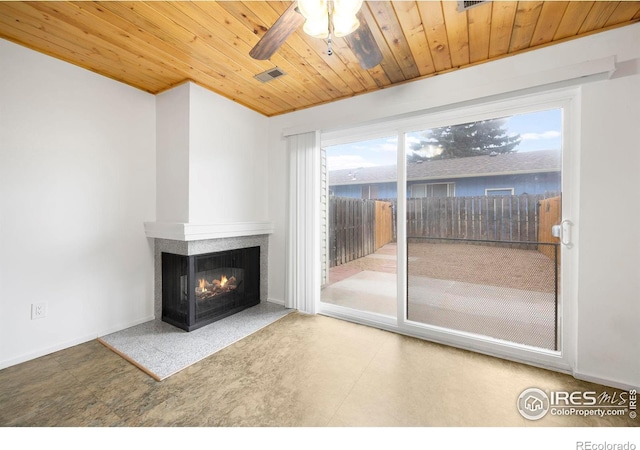 unfurnished living room with a multi sided fireplace, ceiling fan, and wooden ceiling