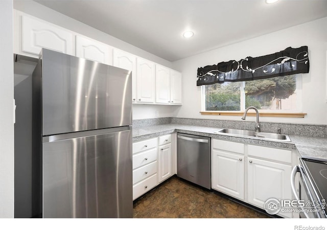 kitchen with stainless steel appliances, white cabinetry, and sink