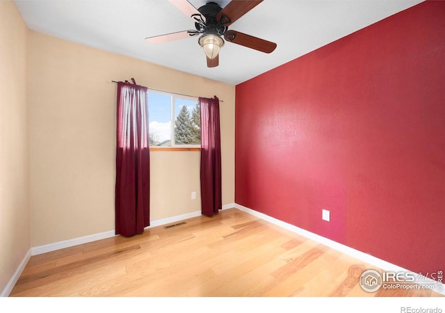 unfurnished room with ceiling fan and light wood-type flooring