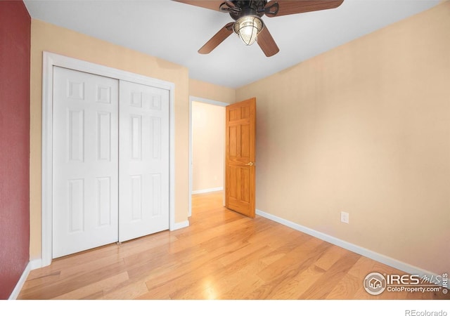 unfurnished bedroom with light wood-type flooring, a closet, and ceiling fan