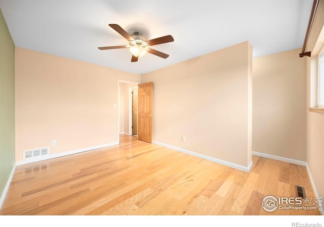 empty room with ceiling fan and light wood-type flooring