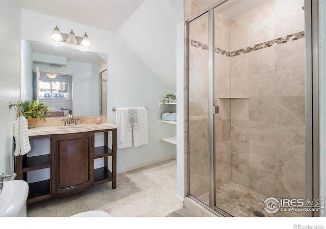 bathroom featuring vanity, a shower with door, and vaulted ceiling