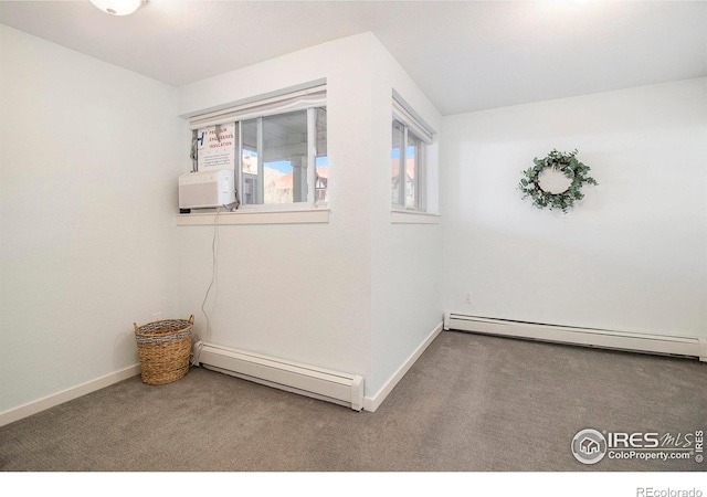 spare room featuring carpet floors and a baseboard radiator