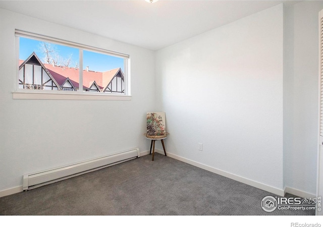 spare room featuring carpet, baseboards, and baseboard heating