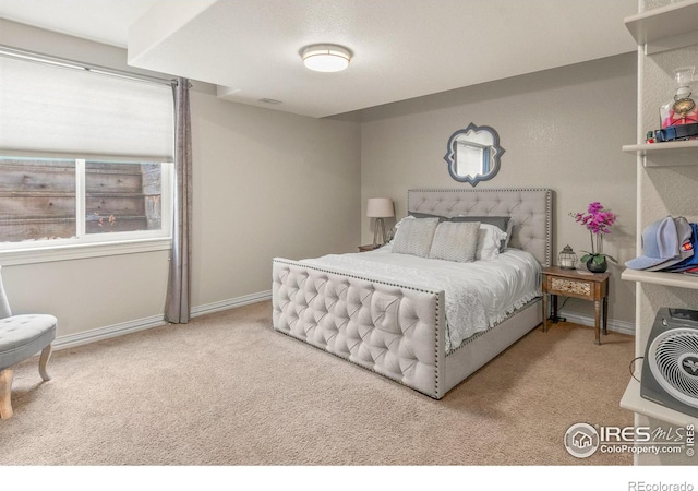 bedroom featuring light colored carpet