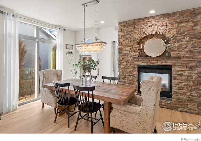 dining area with a fireplace and light wood-type flooring