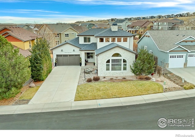 view of front of house with a garage and a front lawn