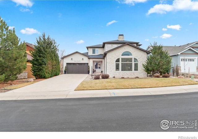 view of property featuring a garage and a front yard