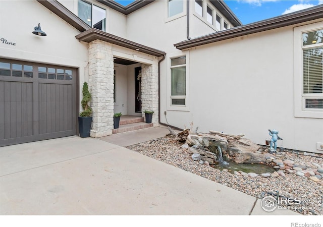 doorway to property with a garage