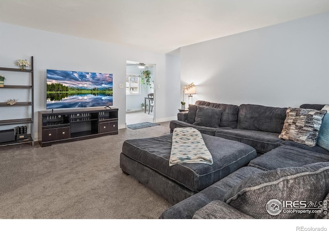 carpeted living room with ceiling fan