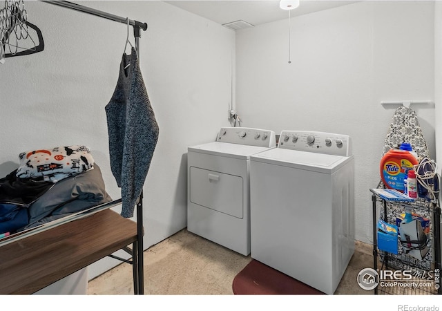 laundry area featuring washing machine and clothes dryer