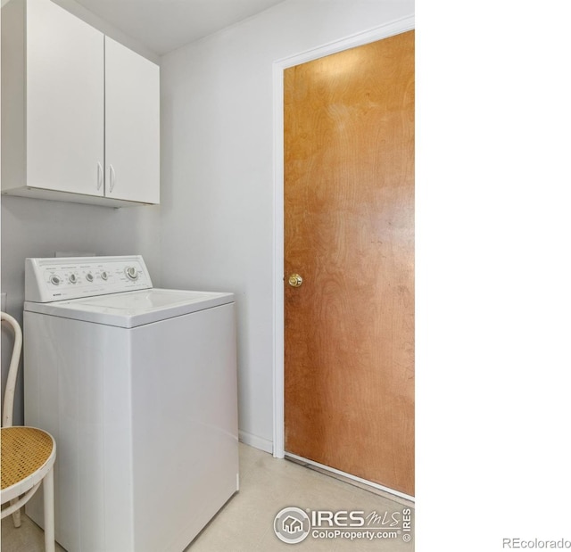 washroom with cabinets and washer / clothes dryer