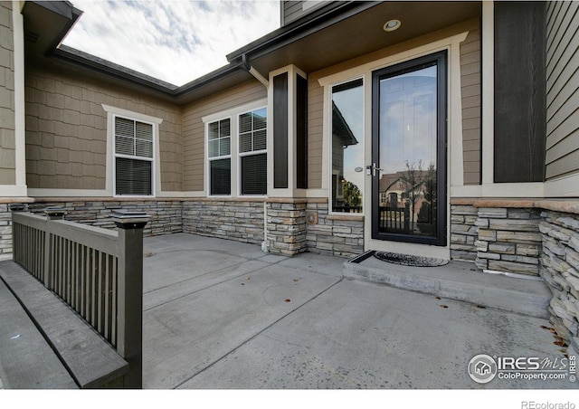 view of exterior entry featuring a patio area