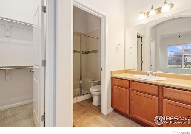 8685 Blackwood Dr, Windsor, CO 80550 - full bath with toilet, a stall shower, vanity, and a spacious closet
