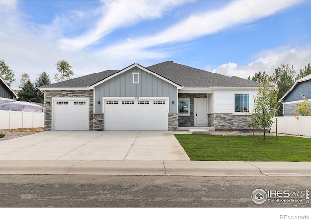 view of front of house with a garage and a front lawn