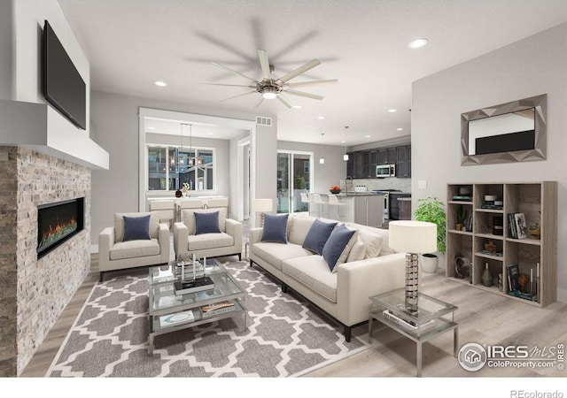 living room with hardwood / wood-style flooring and ceiling fan