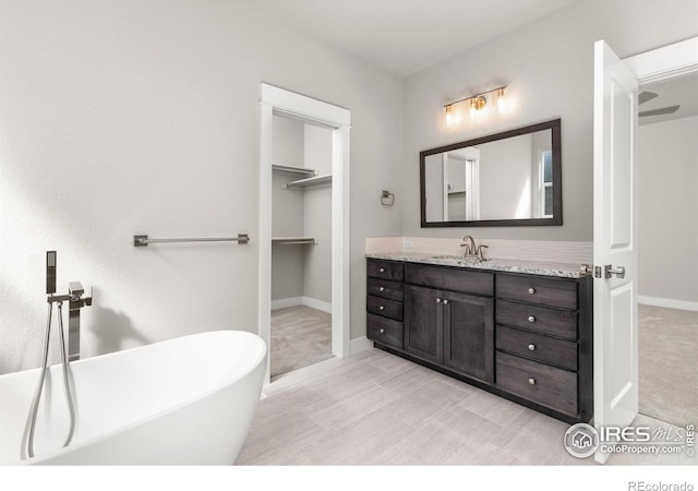 bathroom featuring vanity and a tub