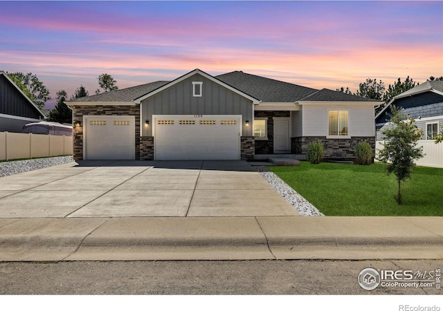 view of front of property featuring a garage and a lawn