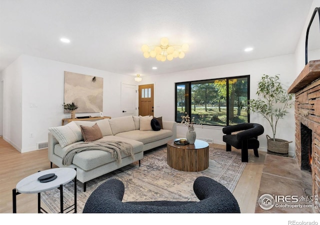 living room with a fireplace and light hardwood / wood-style flooring