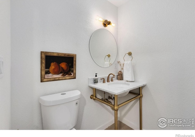 bathroom featuring sink and toilet