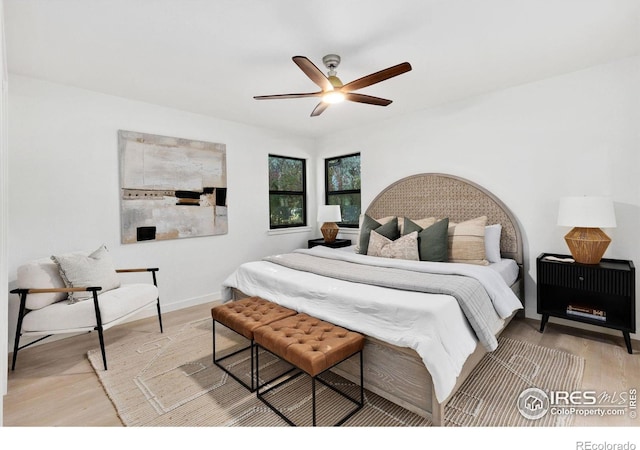 bedroom with light hardwood / wood-style floors and ceiling fan