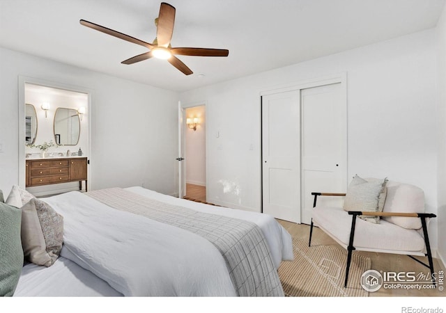 bedroom with ensuite bath, ceiling fan, a closet, and light hardwood / wood-style flooring