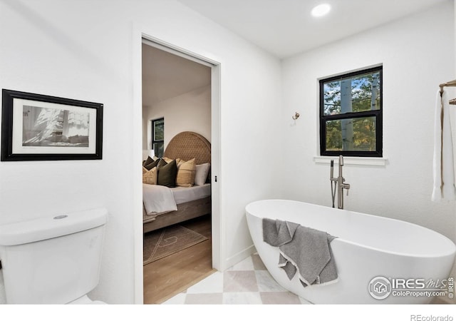 bathroom featuring toilet and a bathing tub